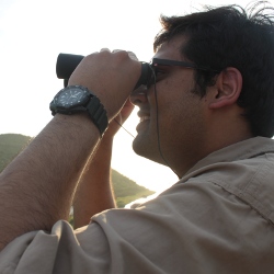 Picture of Pinaki looking at something through binoculars.
